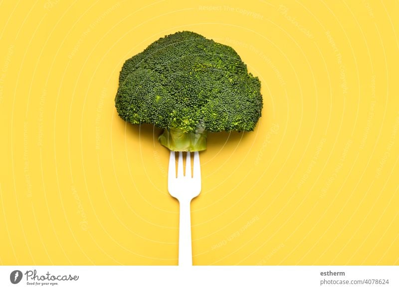 Fresh broccoli on a white plastic fork.Healthy food lifestyle vegetable closeup dietetic kitchen healthy food product vegan eating wholesome nobody cooking