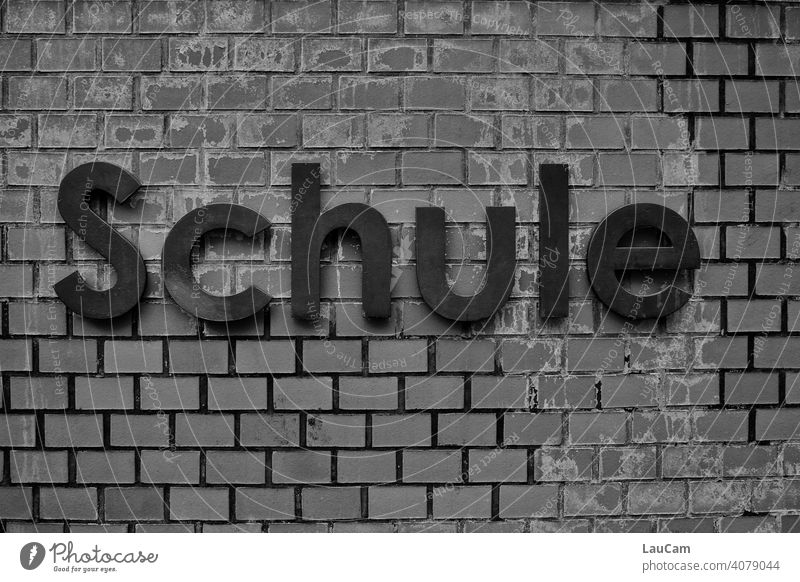 Black lettering "School" on a brick wall School building School at home Education Study writing Word Wall (building) house wall clinker facade