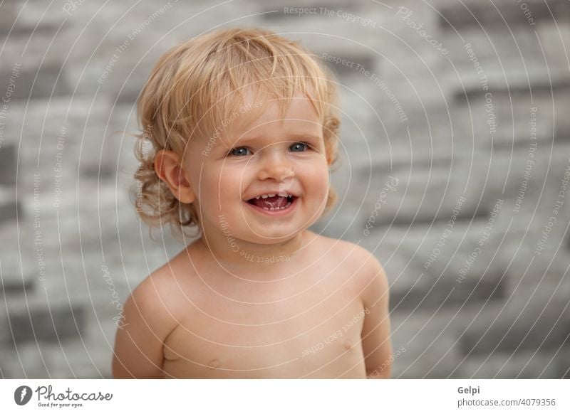 Happy baby one years old with blond and curly hair cute child white expression cool summer outside toddler boy happy caucasian little kid lifestyle beautiful