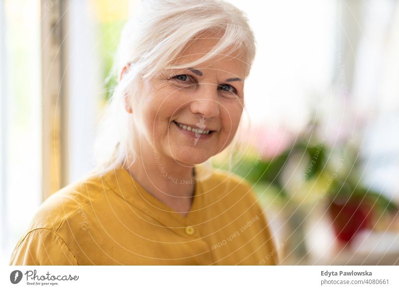Portrait of an mature woman at home smiling happy enjoying positivity vitality confidence people senior casual female Caucasian elderly house old aging