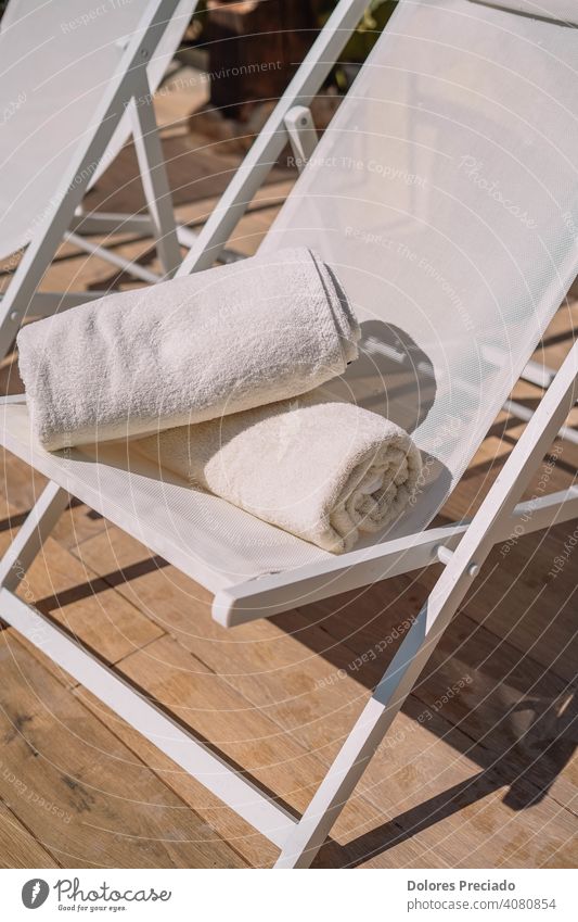 Two folded pool towels on a hotel chair comfort hygiene pastel beauty organise tidy resort pile care body shower wellness dry laundry wash relax cotton bath spa