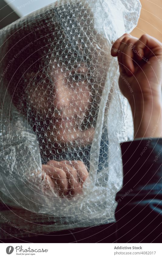 Woman entangled in bubble wrap woman female plastic reduce resources destruction trash pollute garbage sustainability disposal concept environmental