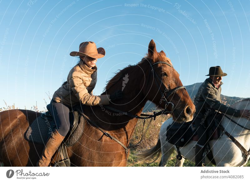 Woman on horse in field woman looking away countryside rider nature sky cloudless blue female sunny daytime lifestyle leisure freedom young animal creature