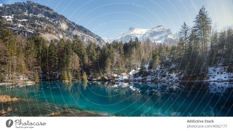 Tranquil blue lake in snowy mountains resort switzerland landscape nature azure water travel forest winter valley scenic tourism peace serene tranquil calm