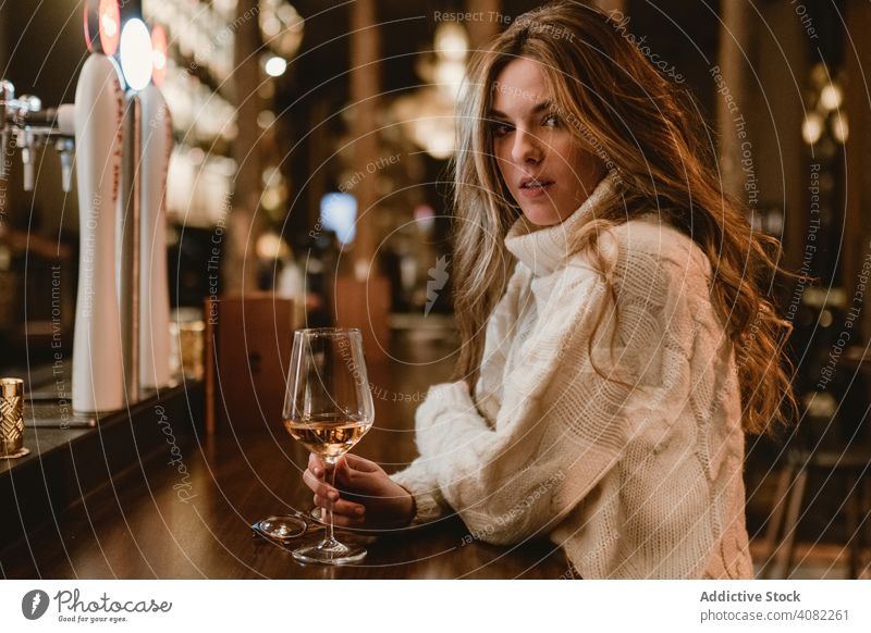 Stylish woman drinking wine in bar standing glass counter young style elegant female alcohol booze beverage goblet pub restaurant lifestyle leisure relax lady