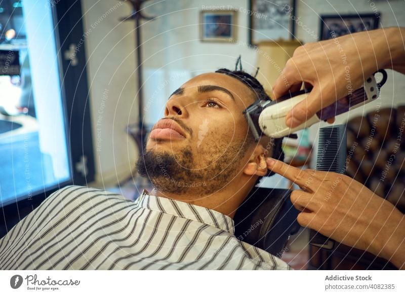 Anonymous hairstylist doing a haircut barber customer grooming barber shop trimming razor man face style hairdress mirror salon hairdresser black