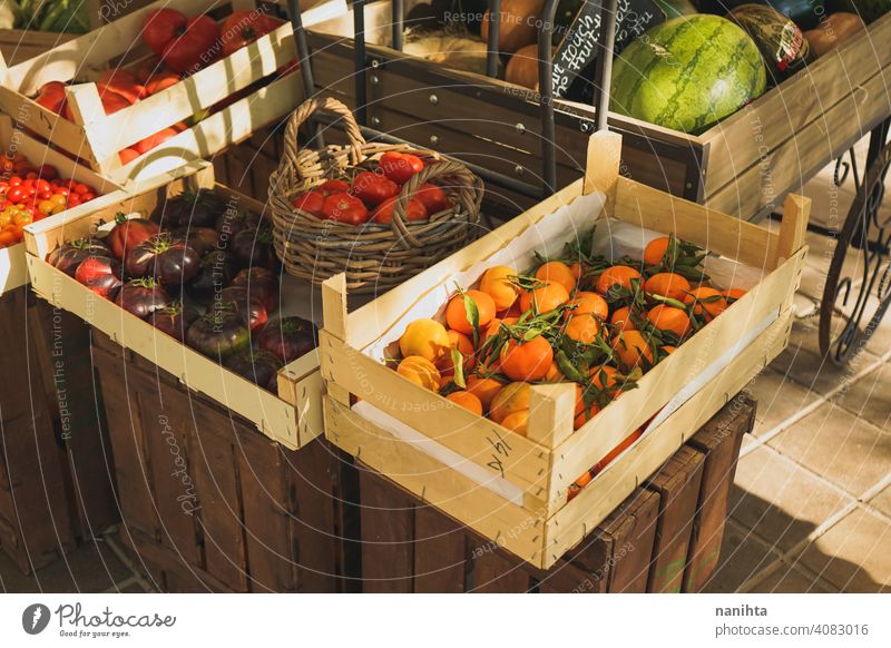 Self service fruit store with many organic products stall vegetables market delicious variety tomatoes clementines citrus fruits wood wooden basket harvest