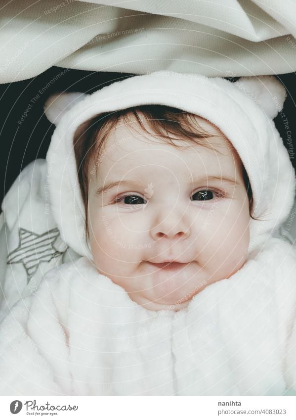 Lovely portrait of a baby girl wearing winter clothes infancy cute little face eyes gray eyes newborn parenthood child cutie lovely adorable cozy pose