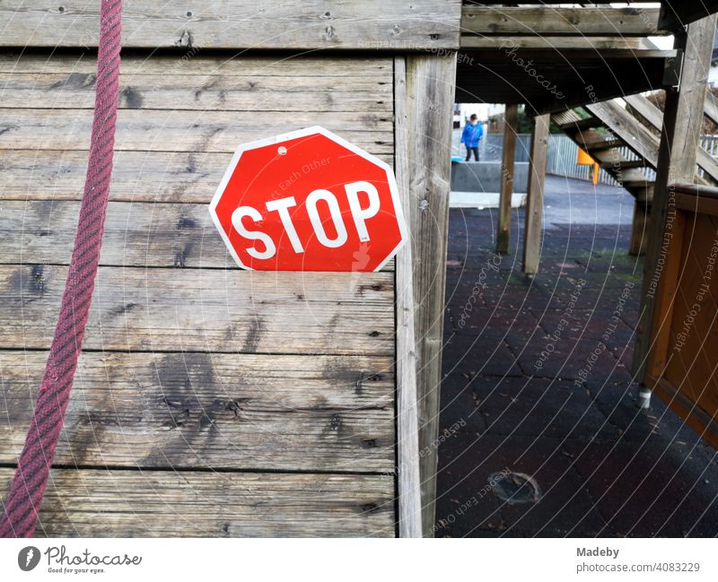 Stop sign in the wooden gap of a climbing frame on the schoolyard of the elementary school in Wettenberg Krofdorf-Gleiberg near Giessen in Hesse, Germany stop