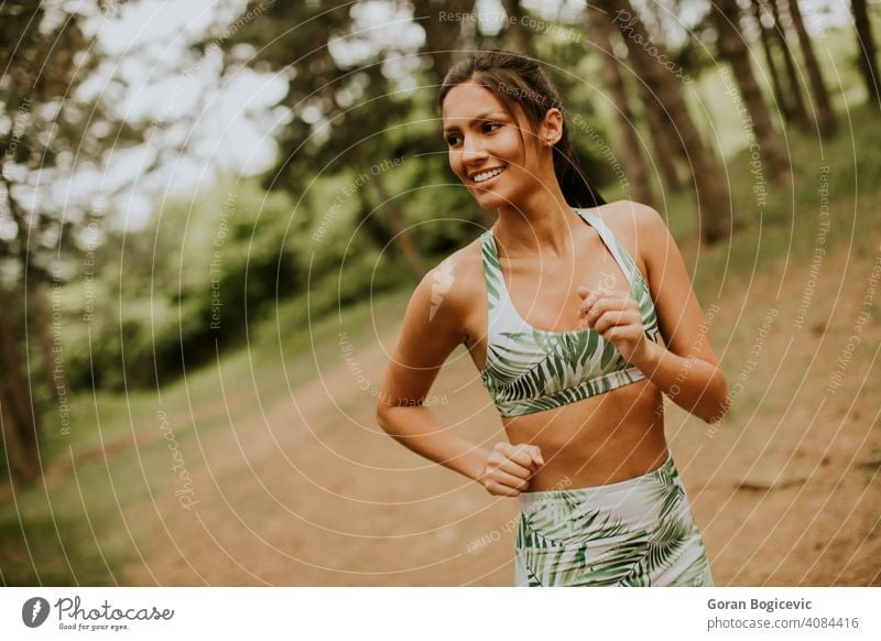 Young fitness woman running at forest trail female athlete park active green exercise young outdoor runner jogging training jogger tree lifestyle sport rural