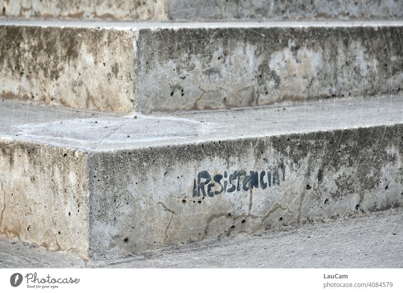 Black lettering "Resistencia" on a grey stone staircase at the Velodrom in Berlin Stairs Stone Concrete Subdued colour Deserted Gray Text writing resistance