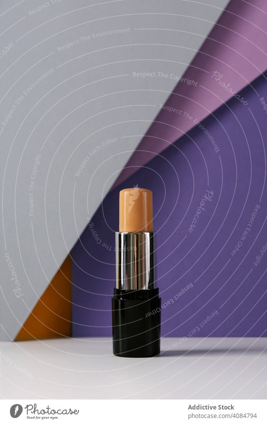 Concealer stick on modern background with geometric shapes. nobody still life fashion beige cosmetic tone funny space make cover base face concealers product