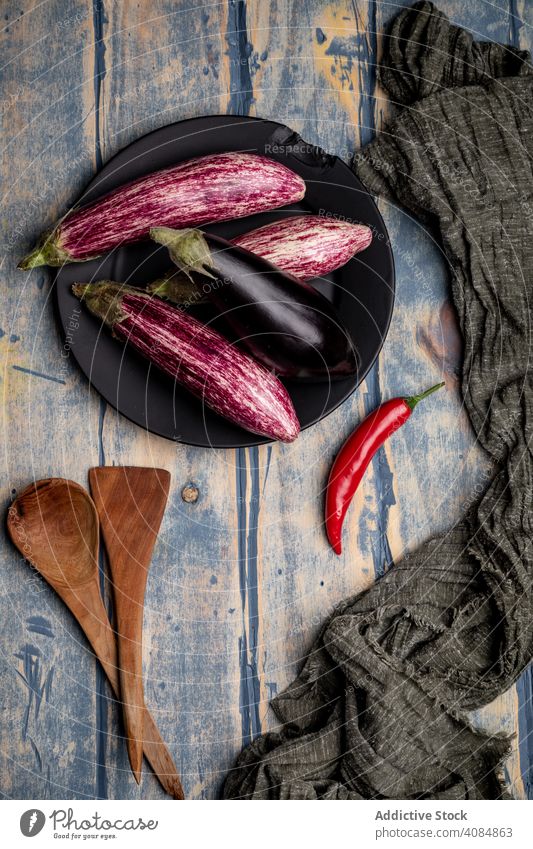 Ripe eggplants on shabby tabletop fabric ripe fresh rustic food healthy vegetable vegan ingredient raw diet cloth napkin weathered grungy agriculture grocery
