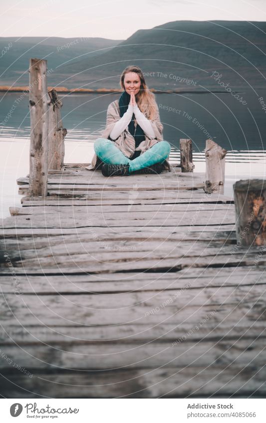 Woman on pier near wonderful lake woman dock water hill amazing shore surface coast sky young nature female mountain hiking lifestyle landscape wear picturesque