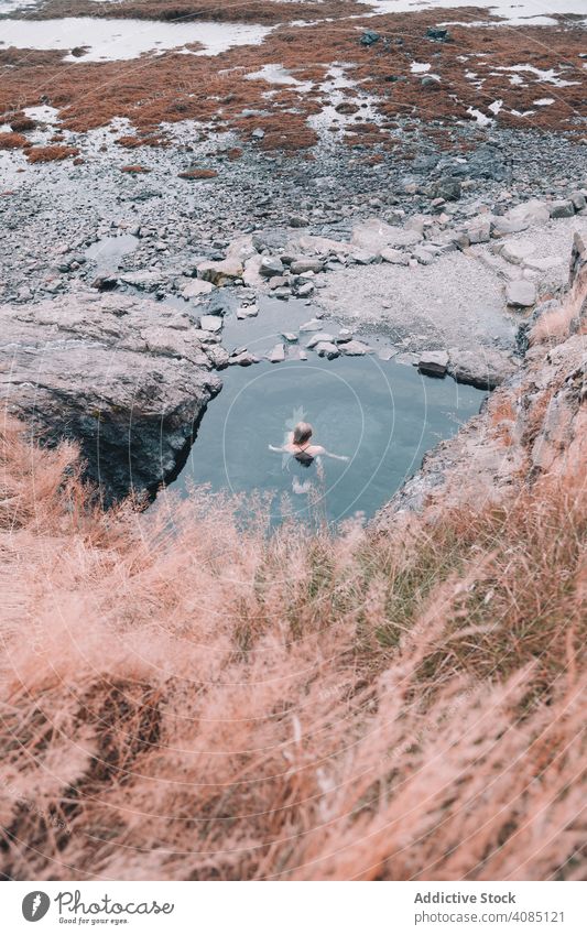 Woman in pond near hill on shore woman cliff water resting coast stone young sea rock summer female relaxation healthy nature leisure lifestyle spa therapy