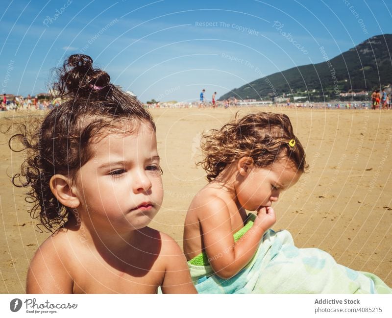 portrait of little girls at beach kid melancholic child outdoor nature sand people happy summer water lifestyle happiness joy vacation childhood beautiful young