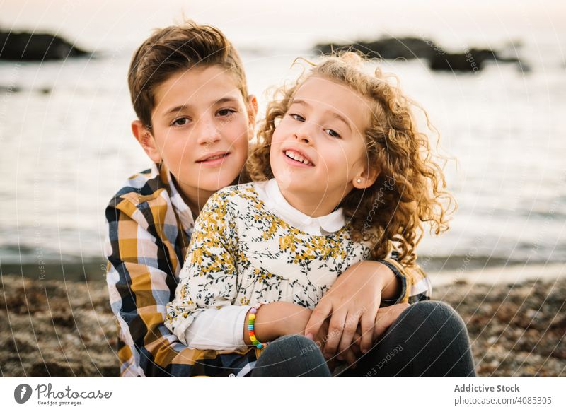 Cute boy and girl hugging each other at beach family seaside vacation kids smiling embrace daughter son togetherness summer sand travel holiday child fun nature