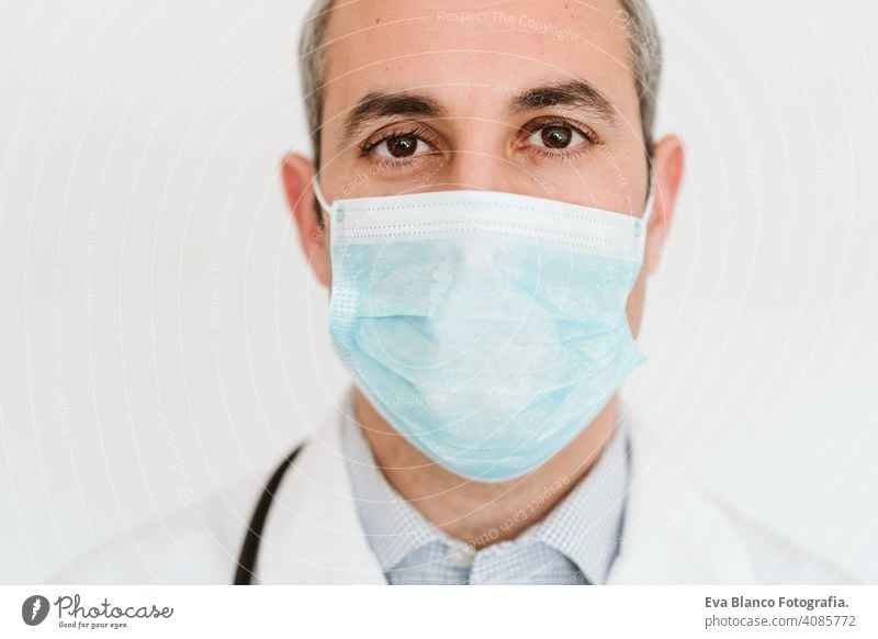 portrait of doctor wearing protective mask and gloves indoors. Corona virus concept man professional corona virus hospital working infection safety epidemic