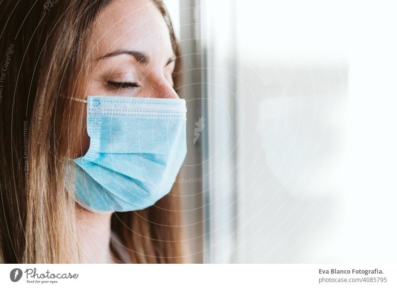 portrait by the window of doctor woman wearing protective mask and gloves indoors. Corona virus concept stop hand professional corona virus hospital working