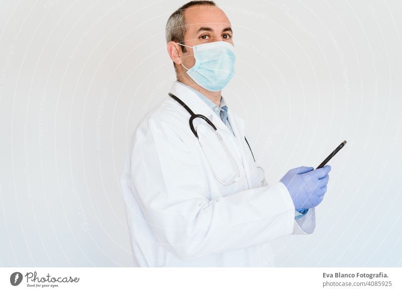 caucasian doctor using protective gloves, mask and mobile phone. Chinese Corona virus concept. 2019-nCoV technology internet wireless man professional
