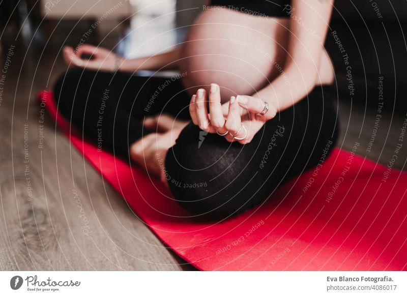 young pregnant woman at home practicing yoga sport. healthy lifestyle caucasian parenting pregnancy bumps single yoga mat mother awaiting motherhood calm