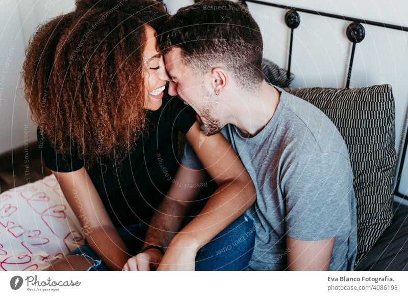 happy couple in love at home. Afro american woman and caucasian man. ethnic love concept afro american bed indoors valentine mixed race february smile cute