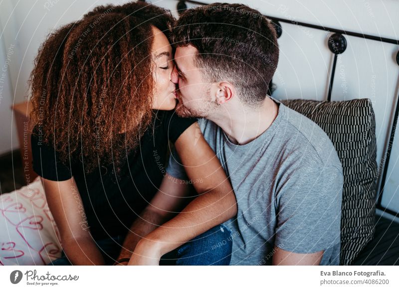 happy couple in love at home. Afro american woman and caucasian man. ethnic love concept afro american bed indoors valentine mixed race february smile cute