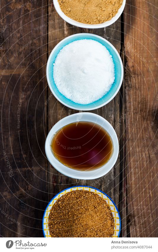 Different Kinds of Sugar and Sweeteners in the Bowls sugar demerara maple syrup honey coconut agave icing caster granulated golden cane dessert brown heap grain