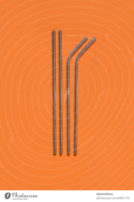 Reusable stainless steel straws on ornage background bag orange top view mockup Eco friendly lifestyle concept monochrome Objects Zero waste Studio Shot