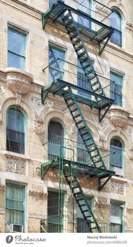 Old building with iron fire escape, New York City, USA. Manhattan old apartment city facade stairs NYC ladder residential urban architecture house America