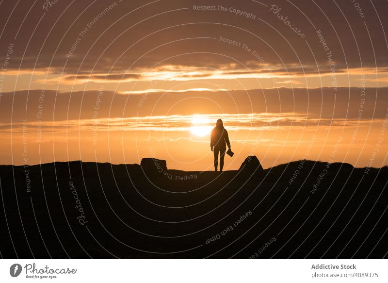 Woman with book standing at sunset woman silhouette people lifestyle female nature sunrise wales one freedom human happiness concept happy sunlight success