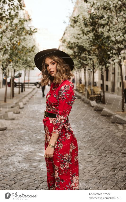 Trendy lady walking on old pavement woman stylish sensual city street path young female outfit hat dress way aged ancient pedestrian trendy elegant lifestyle