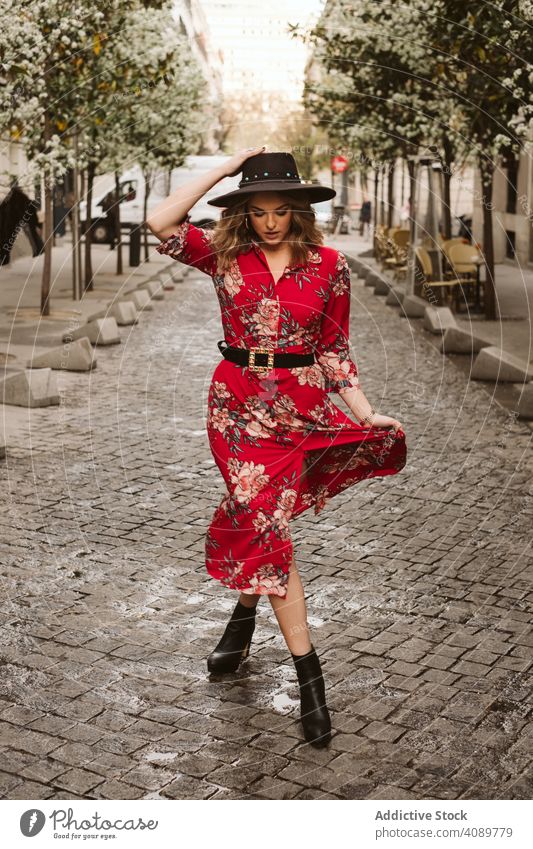 Trendy lady walking on old pavement woman stylish sensual city street path young female outfit hat dress way aged ancient pedestrian trendy elegant lifestyle