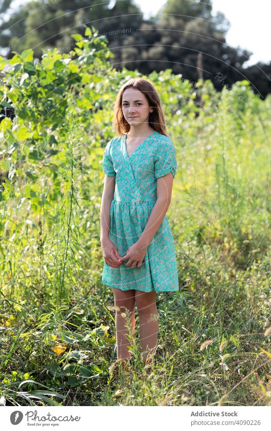 Portrait of teenager in agricultural field portrait harvest farm agriculture catalonia spain anoia summer nature girl sunny daytime standing dress containers