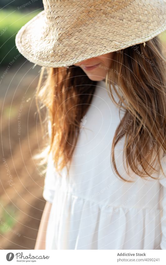 Portrait of anonymous teenager with hat on filed portrait field farm sprouts summer nature sunny daytime catalonia spain anoia girl young rural rustic