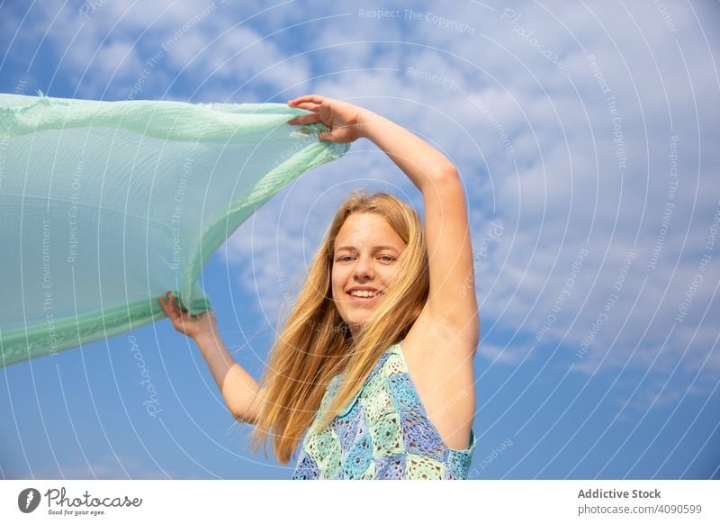 Girl holding thin fabric pareo girl summer vacation lifestyle travel beach young ocean people sunny teenager smiling blue happy attractive beautiful sky leisure