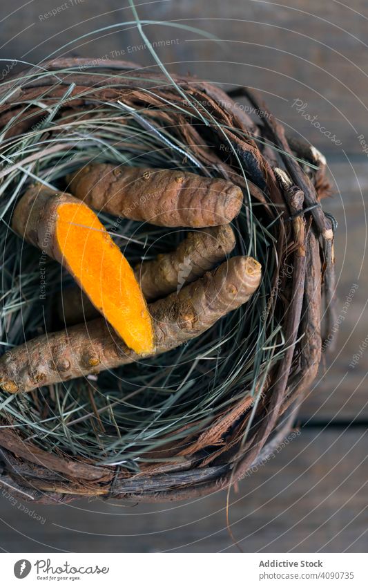 Boiled carrot in nest tumeric spice raw table colorant kitchen vegan food soft sweet yummy tasty twigs grass sprigs vegetarian vegetable rustic composition
