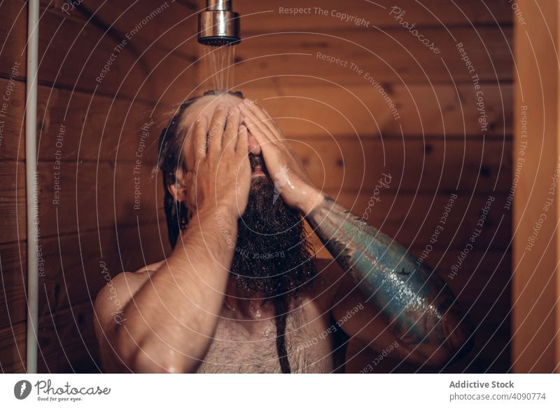 Man taking shower in wooden bathroom man water male wet clean care hygiene healthy hipster person handsome morning fresh bearded washing hair showering nude