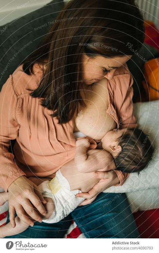 Mom breastfeeding at home mother baby newborn love care parent babyhood happiness innocent young woman infant kid child mom lovely adorable cute happy beautiful