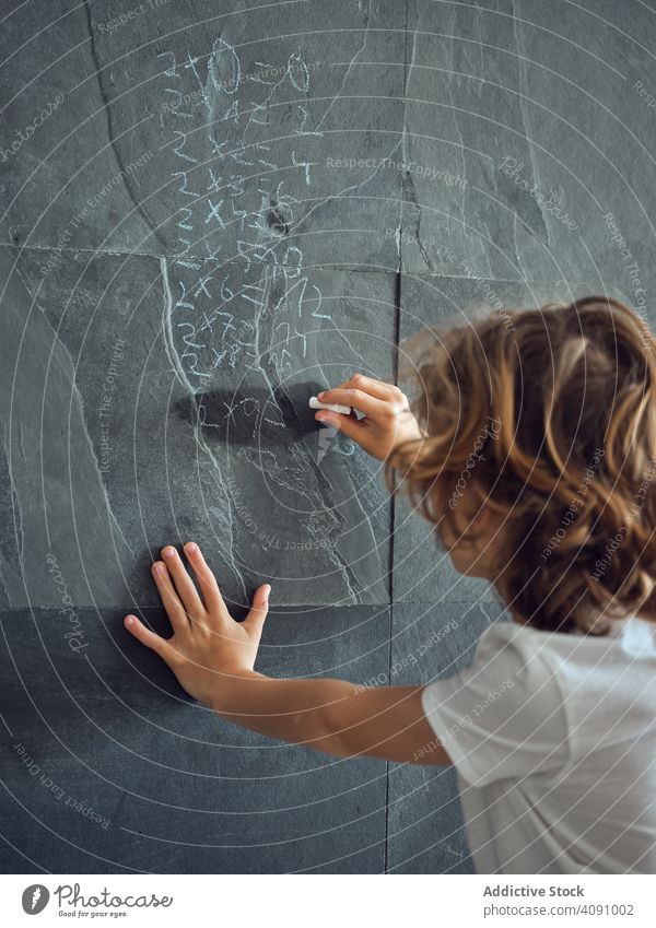 Boy writing multiplication table on wall boy education child study learn school kid studying knowledge person people lesson math primary little cute chalk black