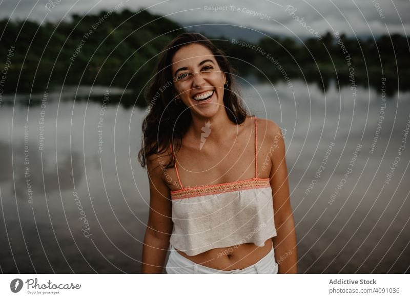 Portrait of Cheerful woman in nature portrait looking at camera smiling lake young water female calm tranquil cheerful happy joy activity lady lifestyle leisure