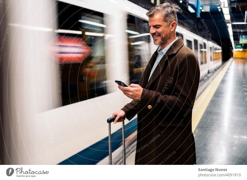 Business man using smartphone in the underground. person lifestyle people middle aged handsome senior caucasian city adult male portrait casual urban confident