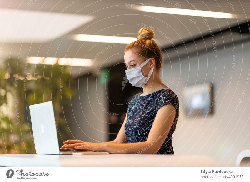 Woman wearing protective face mask in the office for safety and protection during COVID-19 woman girl people Entrepreneur business businesswoman successful