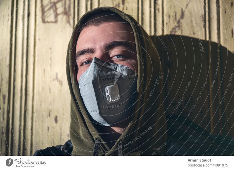 portrait of a young man with a FFP3 corona mask ffp3 protection pandemic pollution virus health care disease infection protective corona virus toxic caucasian