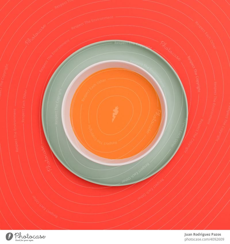 Gazpacho bowl on a blue plate and red background. Top view. colorful creative delicious diet dish drink fresh gazpacho geometry health care healthy legumes