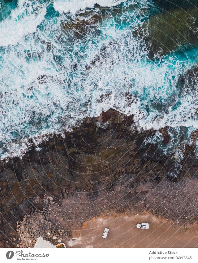 Drone view of coast with cliffs coastline waves drone view rocky splashing remote aerial foamy daylight spain tenerife water height ocean landscape high nature
