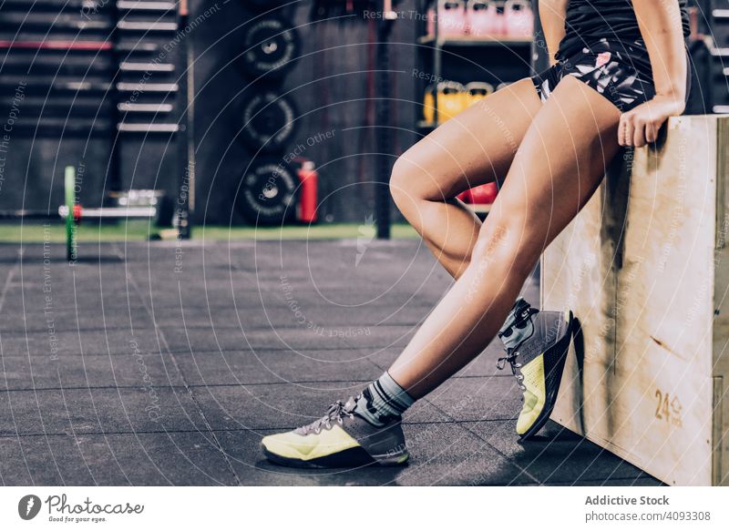 Slender woman having break in fitness club relax gym tired slender sportswear female lifestyle training healthy workout exercise sitting body slim wellness