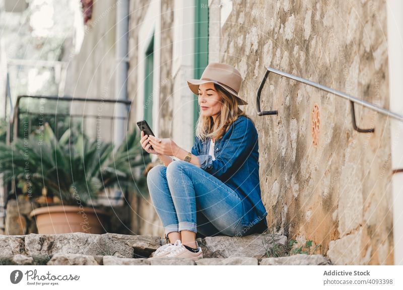 Woman with smartphone sitting on stone steps of stairs woman happy beautiful talking attractive charming relaxation street female confident model communication