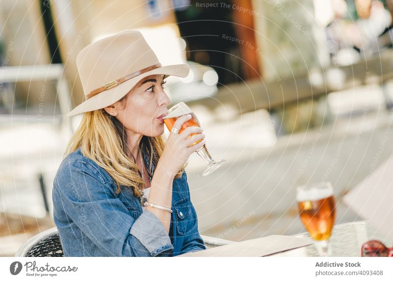 Beautiful woman drinking sitting in outside cafe beer beautiful charming relaxation glass happy female street confident model smile lovely lager beverage