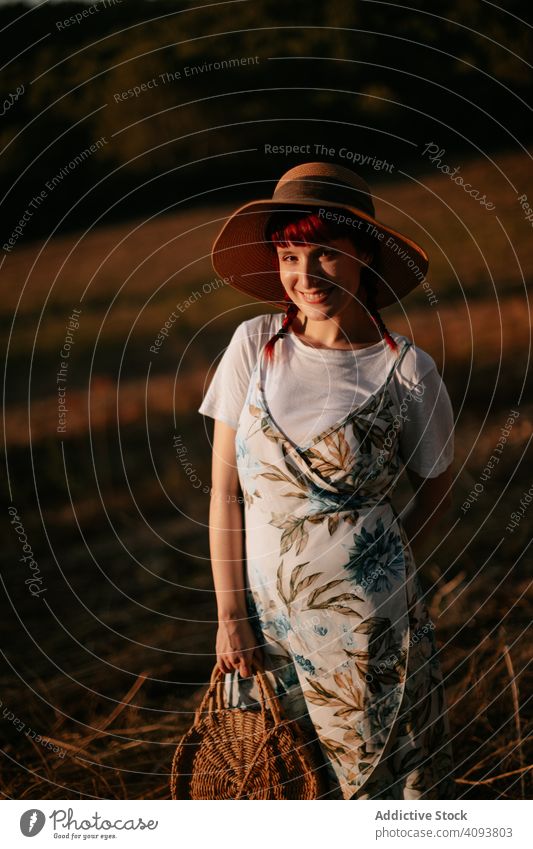 Woman walking in field woman sunset retro nature evening sky countryside lifestyle female summer meadow vintage dress hat harmony idyllic calm tranquil serene